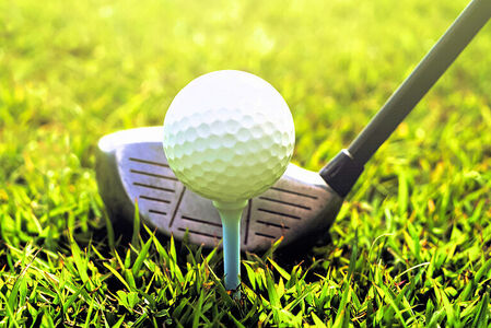 Golf Ball on Tee in Grass, ready to be hit with a Golf Club - Golf Courses and Pro Shops Merchant Accounts