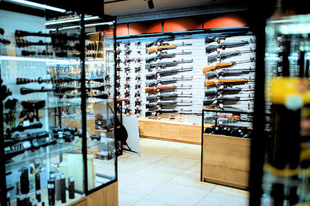 Merchant Credit Card Processing and ACH for Gun Shops in Florida - Guns rifles and handguns on racks and in showcases on display.