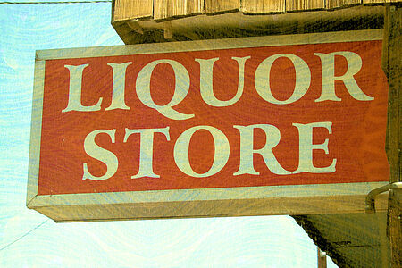 Antique looking wood Liquor Store Sign on the front of a store -  merchant credit card and ACH processing.