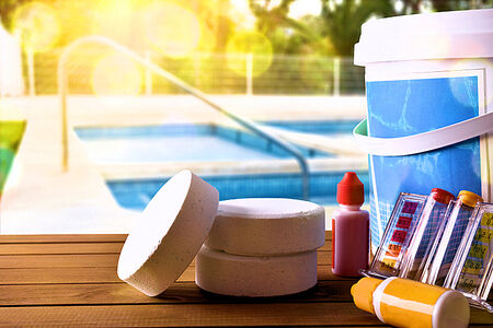 Merchant Credit Card and ACH Processing for Pool Companies Services and Cleaners in Florida in Photo a pool in the background with Chlorine Shock Tablets, and a water testing kit.